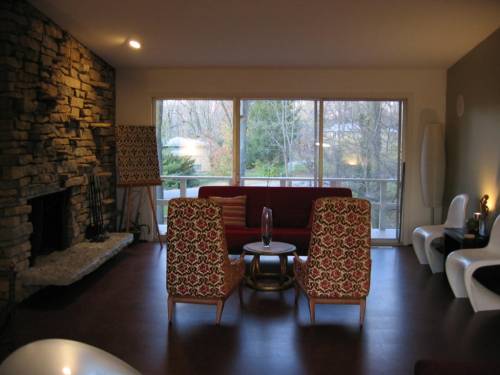 Upper living area (front half) with triple slider to catwalk and stacked stone wall with fireplace