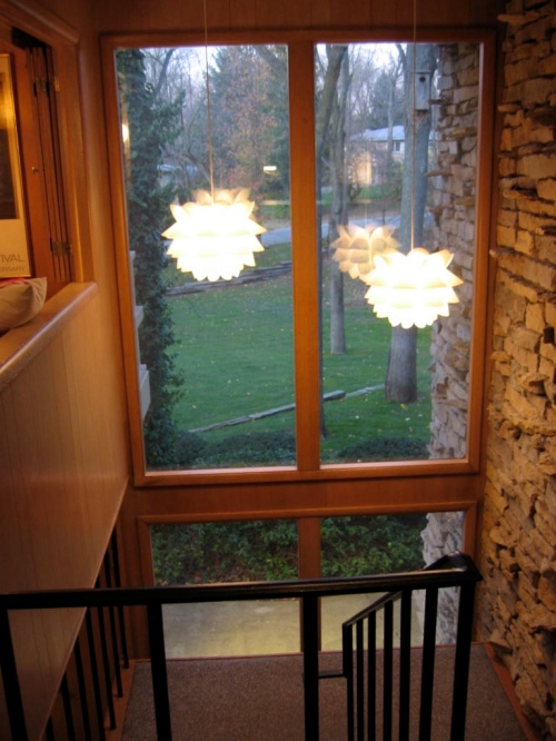 View from upstairs hallway through two-story entry window