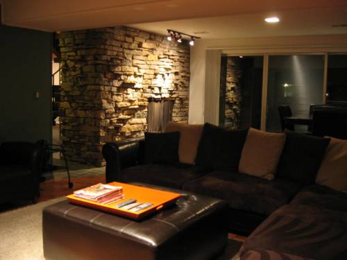 Living area downstairs at night; triple glass slider walkout to front patio