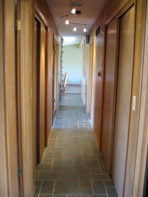 Upstairs hallway, with two large closets, leads from back bedroom to living room