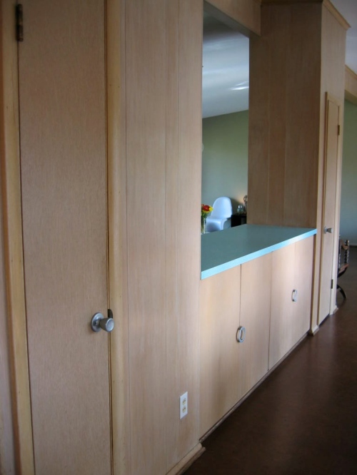 Ample built-in storage in dining area; far door is media closet